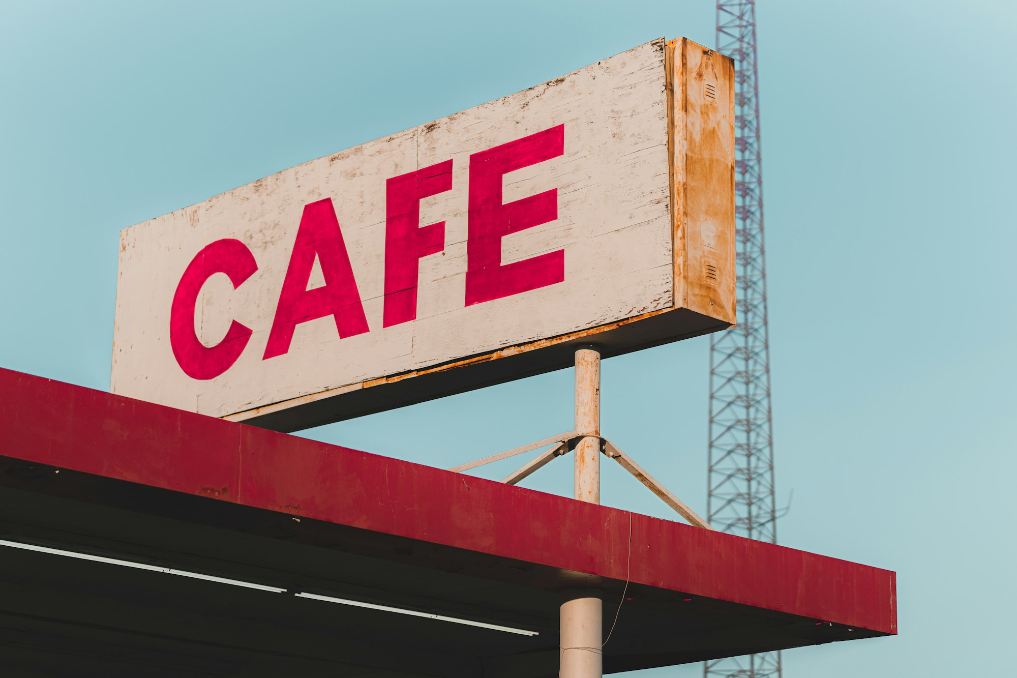 Vintage cafe sign atop a building in the Hi-Desert